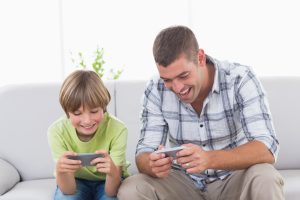 Father and son playing games on phone